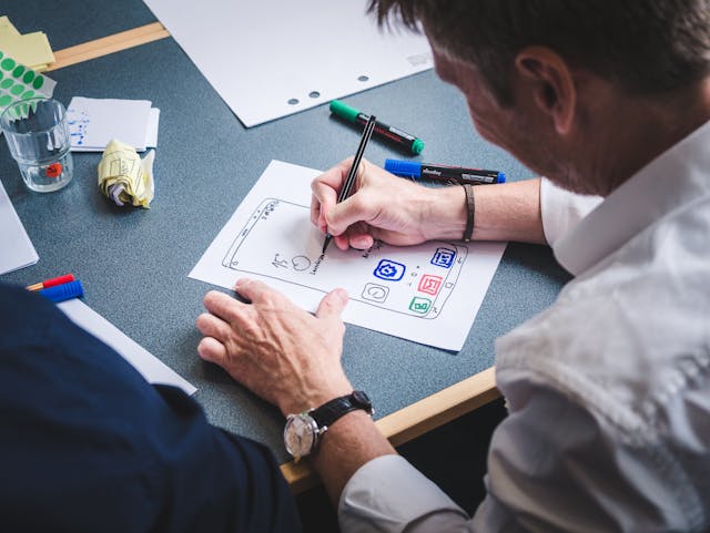 Hommes travaillant sur prototype application mobile au bureau